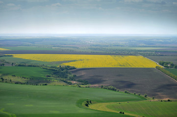 Fototapeta na wymiar birds eye view of fields with farms and roads