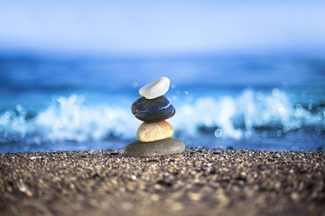 Different pebbles are standing successively at wavy sea side