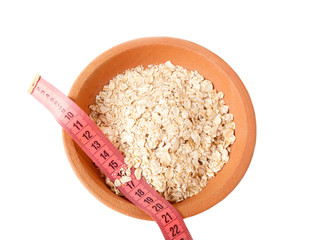 Oat flakes in ceramic bowl and meter.