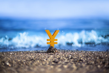 Japanese Yen currency icon is standing on the wavy sea side