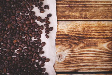 Coffee beans on the wooden background