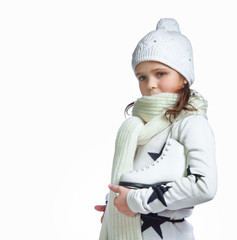 portrait of a little girl holding ice skates