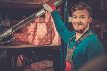 Worker on a automotive spare parts warehouse