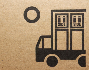 Fine image close-up of grunge black fragile symbol on cardboard