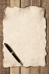 Notepaper and pen on wooden background,Concept filter sepia.