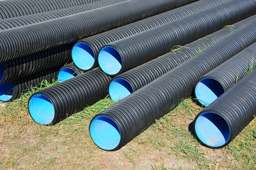Stacked new PVC pipe on construction site