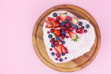 Delicious heart shaped cream cake with berries