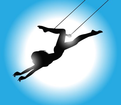 silhouette di trapezista con luce sullo sfondo