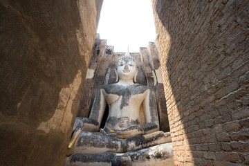Fototapeta na wymiar Big Buddha meditation behind the brick gate