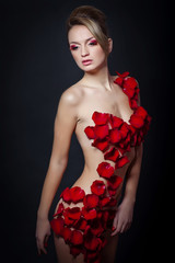 Sexy woman are posing in flowers 