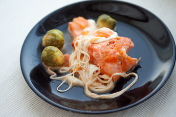homemade food, stew red fish in sauce with Brussels sprouts