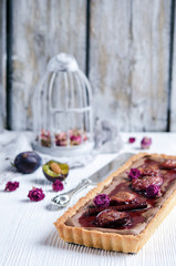Homemade chocolate and coconut cake with plums