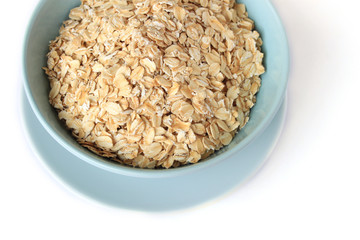 Rolled Oats in a bowl isolated on white background