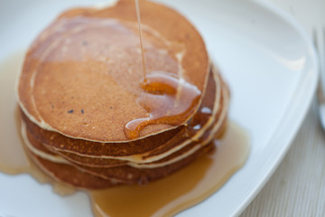 Stack of pancakes with  maple syrup, top view