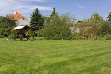 Fototapeta na wymiar Ideal grass meadow near village
