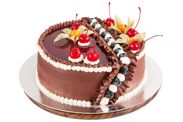 Traditional chocolate cake decorated with cream, cherries and bl