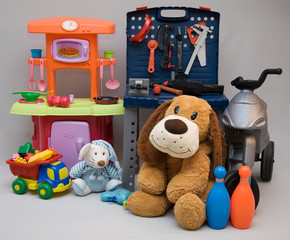 Plastic and stuffed toys on a gray background