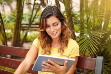 Fototapeta premium Young lady toothy smiling while using tablet