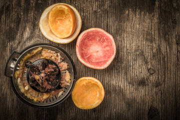 cut citrus fruit and juicer on wooden background