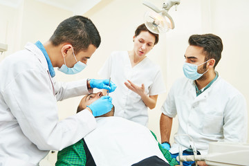 Fototapeta na wymiar Female dentist doctor teaching students
