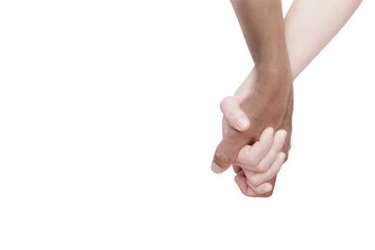 Interracial couple holding hands on white background