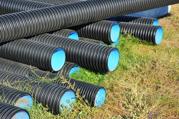 Stacked new PVC pipe on construction site