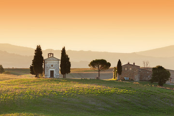 Tuscany landscape at sunrise with a little chapel of Madonna di Vitaleta, Italy.