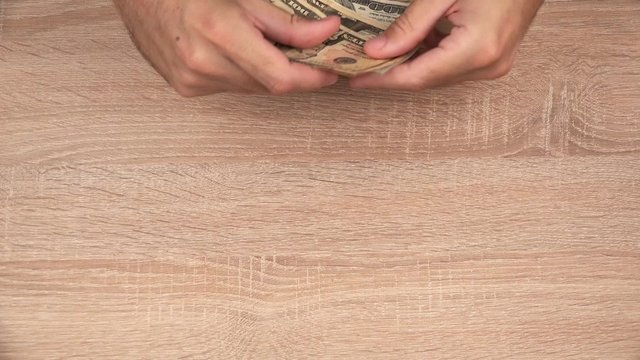 Keep your hands away from my money, man counting cash payment in euro banknotes and hits female hand trying to grab the money.