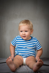 Fototapeta premium portrait of a boy in the studio on a gray background