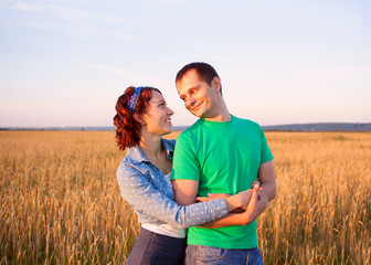happy couple in love in the field