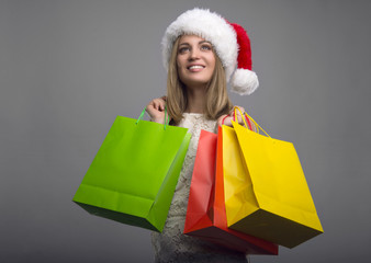 Beautiful young girl with shopping. New Year's Eve. Christmas discounts. Holiday Shopping