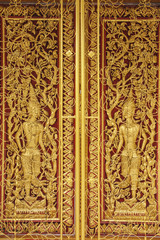 Fototapeta na wymiar Ancient golden wooden door of Thai temple,Thailand