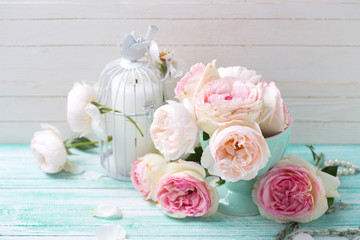 Background with sweet pink roses in vase and candle