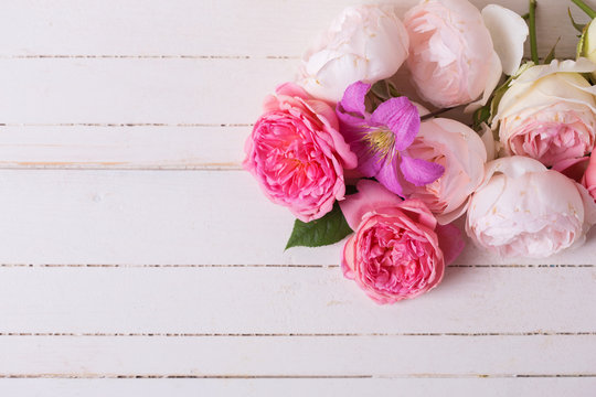 Sweet pastel roses on white  wooden background.