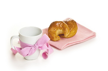 white mug with a ribbon and croissants