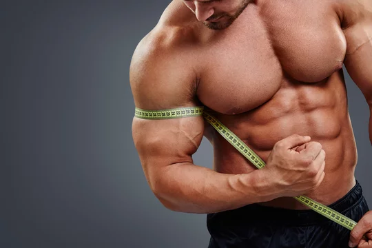 Bodybuilder with tape measure Stock Photo by ©kegfire 86171124