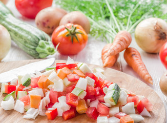 Fresh cut vegetables on the wooden chopping board.
