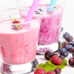 Assorted fruit shakes on white table
