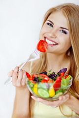 Happy woman making the salad 