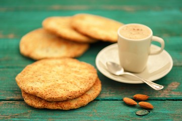 Fresh homemade coffee espresso with froth, silver spoon, almond