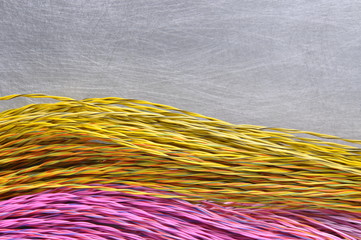 Colored cables and wires on metal background with place for text