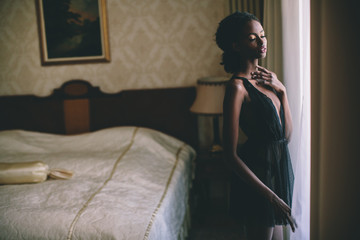 Fototapeta premium Young black woman in the room