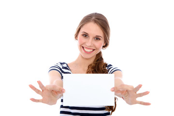Fototapeta premium Student girl showing white blank sheet - copy space, isolated over background