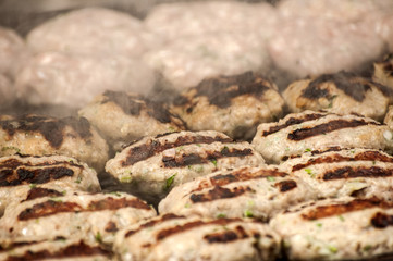 Grilled prepared roasted hot meatballs on grill closeup