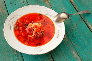 Portion of homemade Russian red beet soup borsch with cabbage an