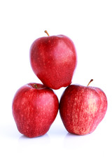 Fresh three red apples isolated on white background.