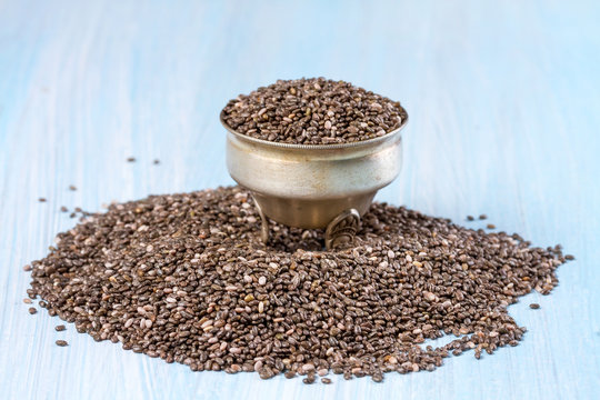 Chia seeds on a blue wooden background © g215