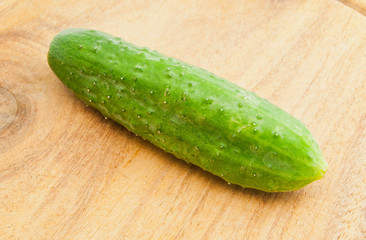 single cucumber on cutting board