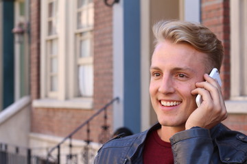 Close up Smiling Attractive Young Guy Talking to Someone Using Mobile Phone