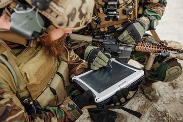commander of the soldiers paves the route on an electronic table